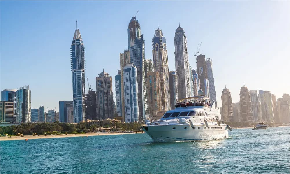Luxury yacht cruising in Dubai with city skyline during summer season