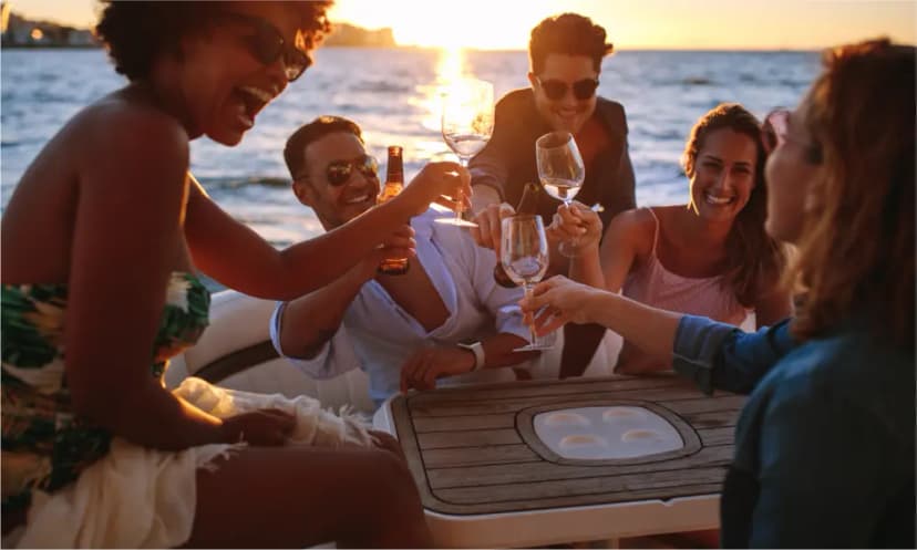 Friends relaxing and having drinks on a private yacht tour in Dubai