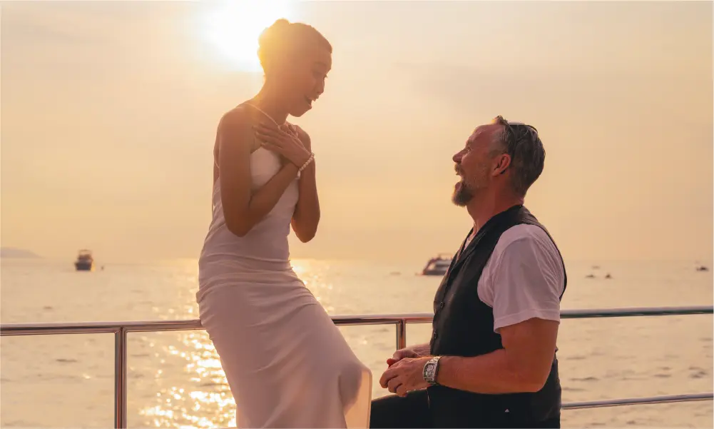 Romantic yacht proposal with Dubai skyline at sunset