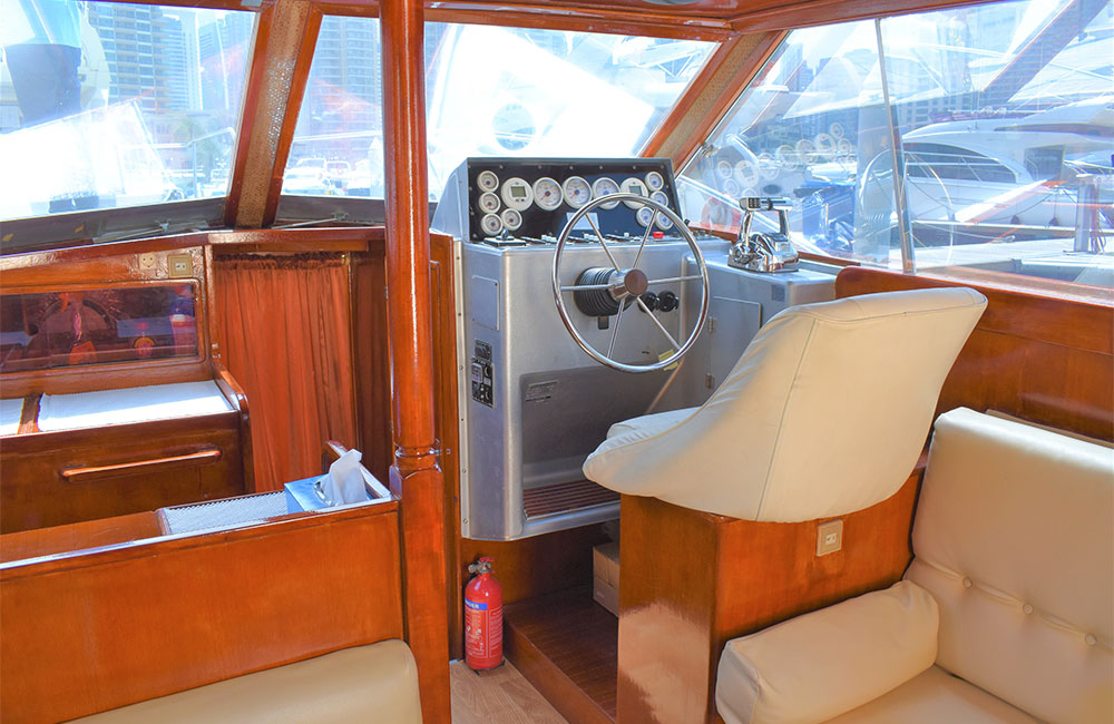 Luxury Yacht having inside control station with classic boat steering wheel finishes look with cozy leather seats